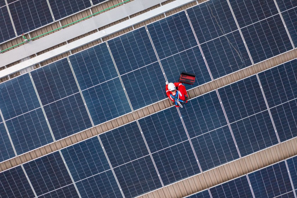 technician installing solar panels